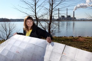 N.C. Beyond Coal organizer Emma Greenbaum shows some of the thousands of petition signatures from community members asking Duke Energy to retire its coal-fired plant in Asheville. (2013)