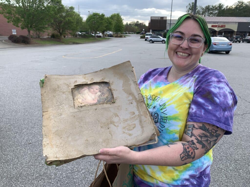 Caitlin Wright holding photo album.