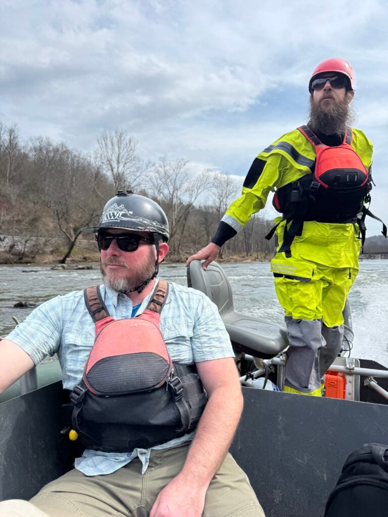 Matt Cook guides a jet boat down the French Broad River