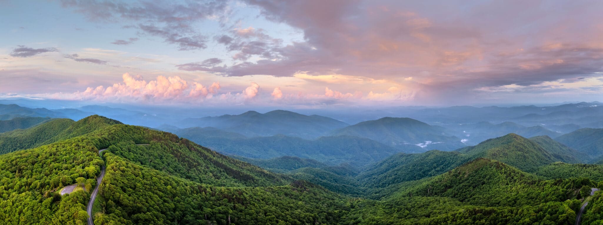 Evening mountain landscape of forest road in North Carolina Appalachians, USA. Blue Ridge Parkway American highway in summer season