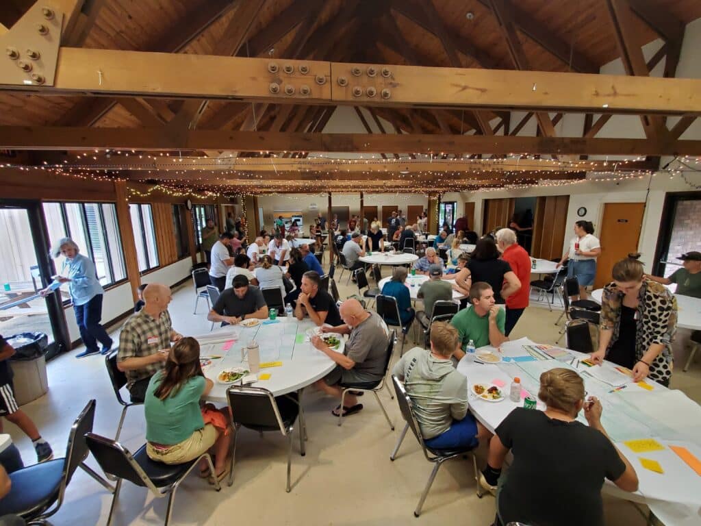 Photo of a group of people taking part in a community engagement meeting in Swannanoa