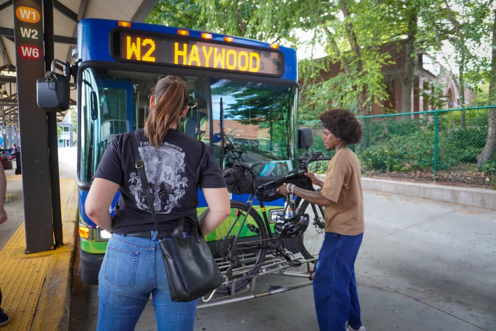 Image of Asheville Bus with riders loading bike